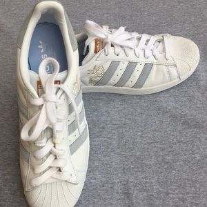 Adidas blue and gold flower superstars